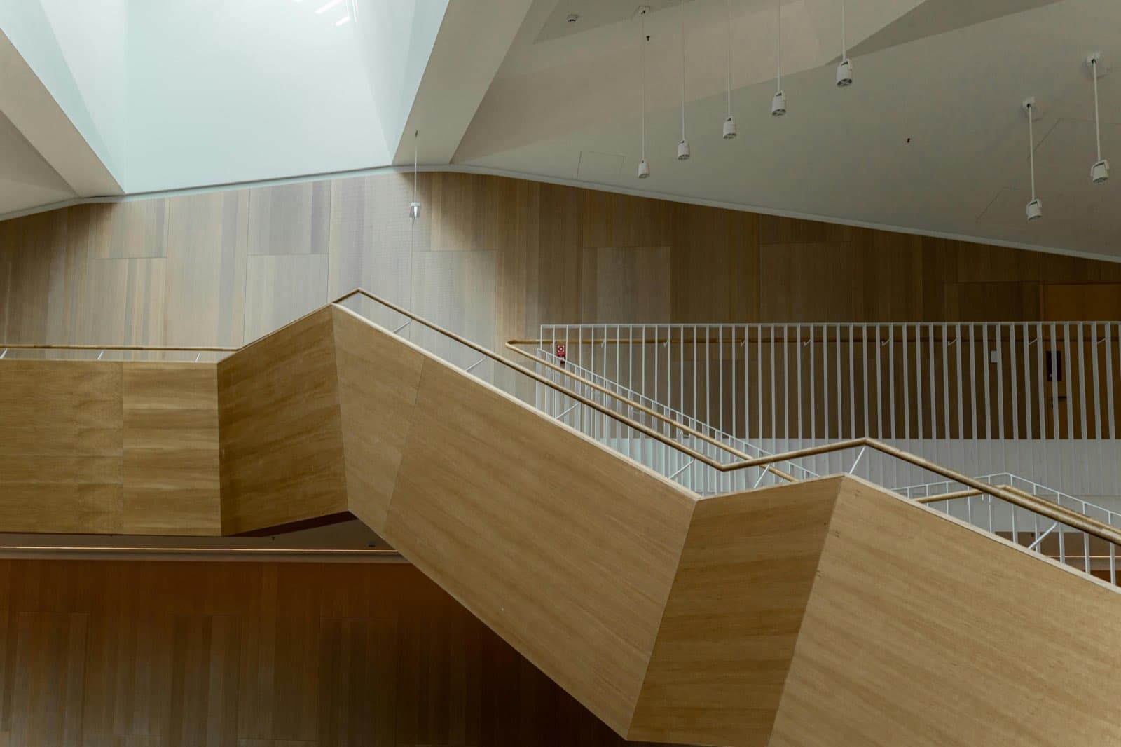 Architectural interior with warm timber and precise geometric stairs